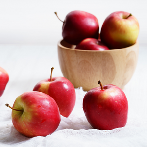 A scene with apples in a bowl on a table. 