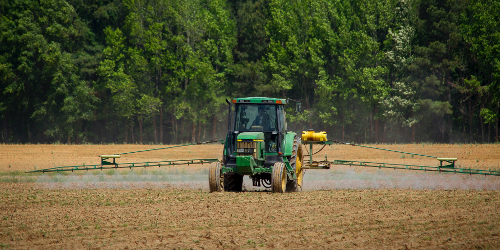 A tractor sprays a field