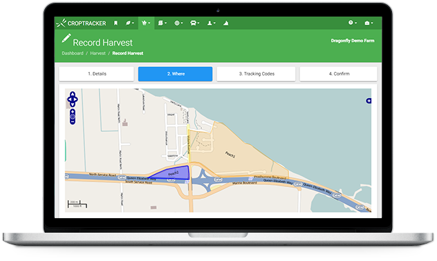 Harvest features displayed on a laptop, the screen shows mapped fields and a harvest location is being selected